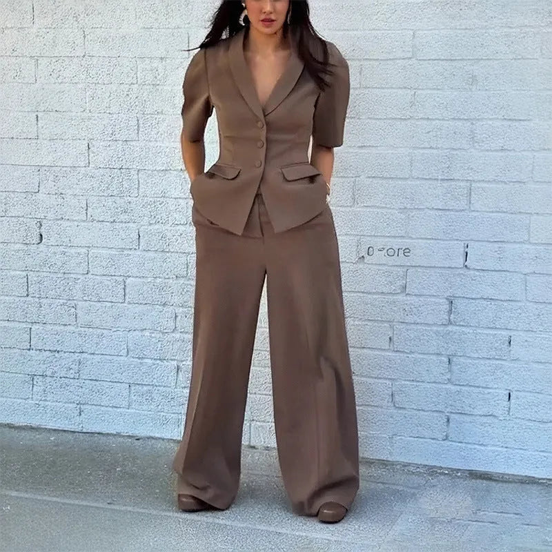 Brown slim fit two-piece polyester suit on a hanger, showing the long sleeve top and trousers.