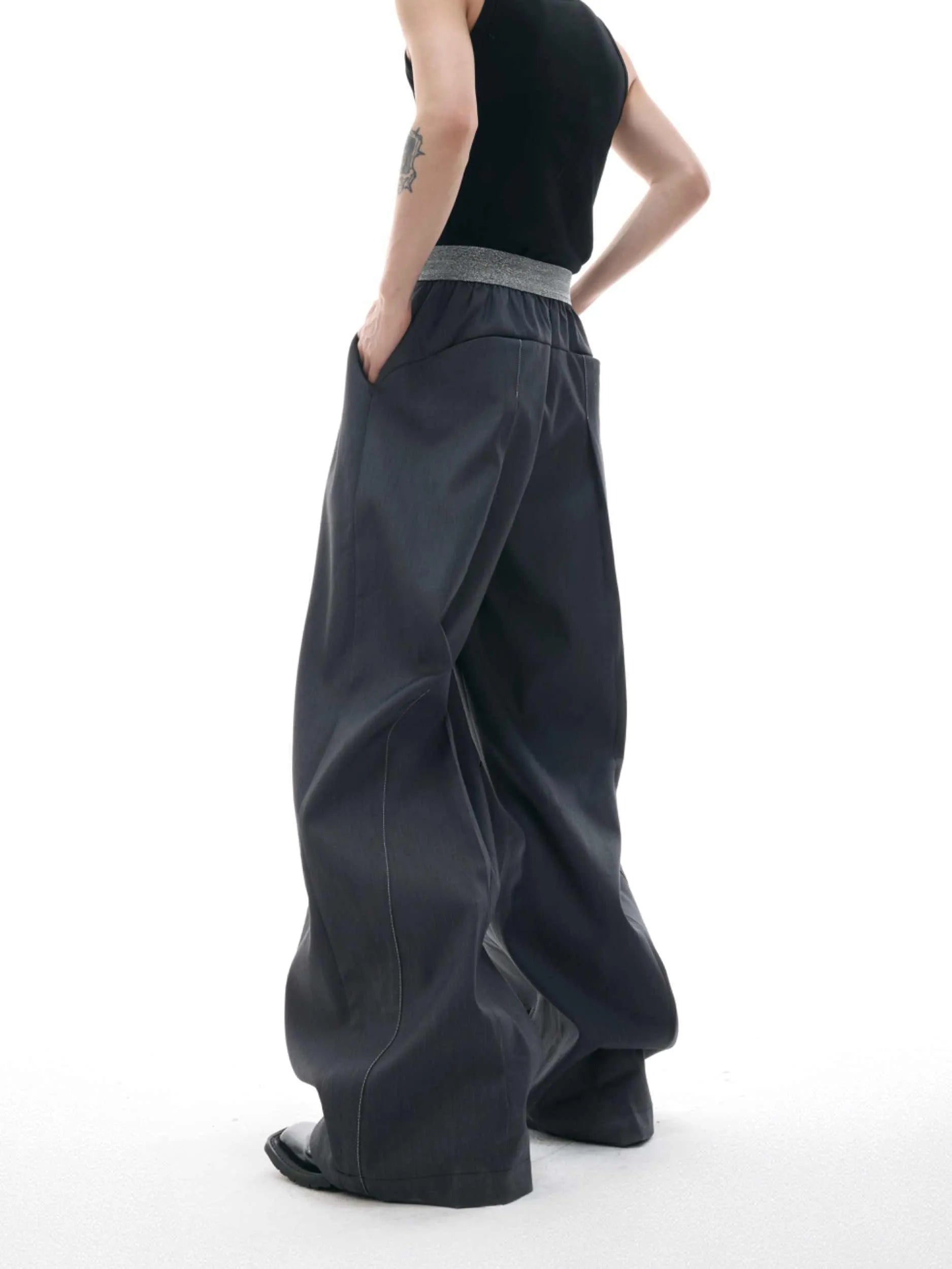 Drooping straight-leg casual trousers with button open line detail in black or grey colours
