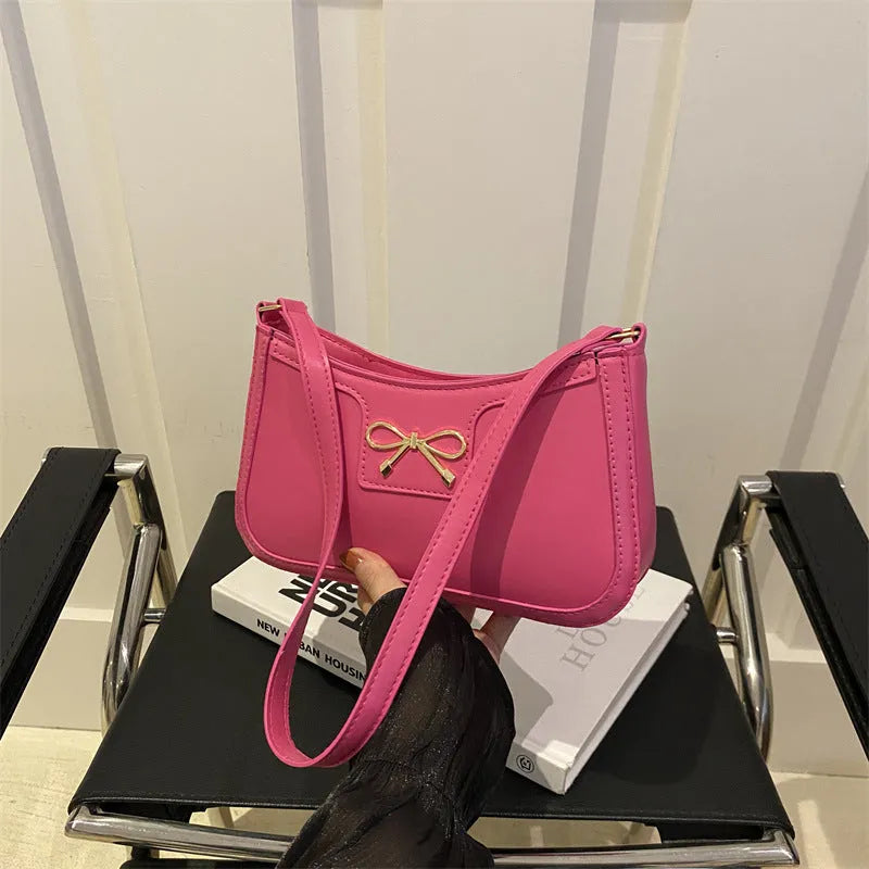 Western style baguette shoulder bag in horizontal square shape with bow decoration, shown in available colours