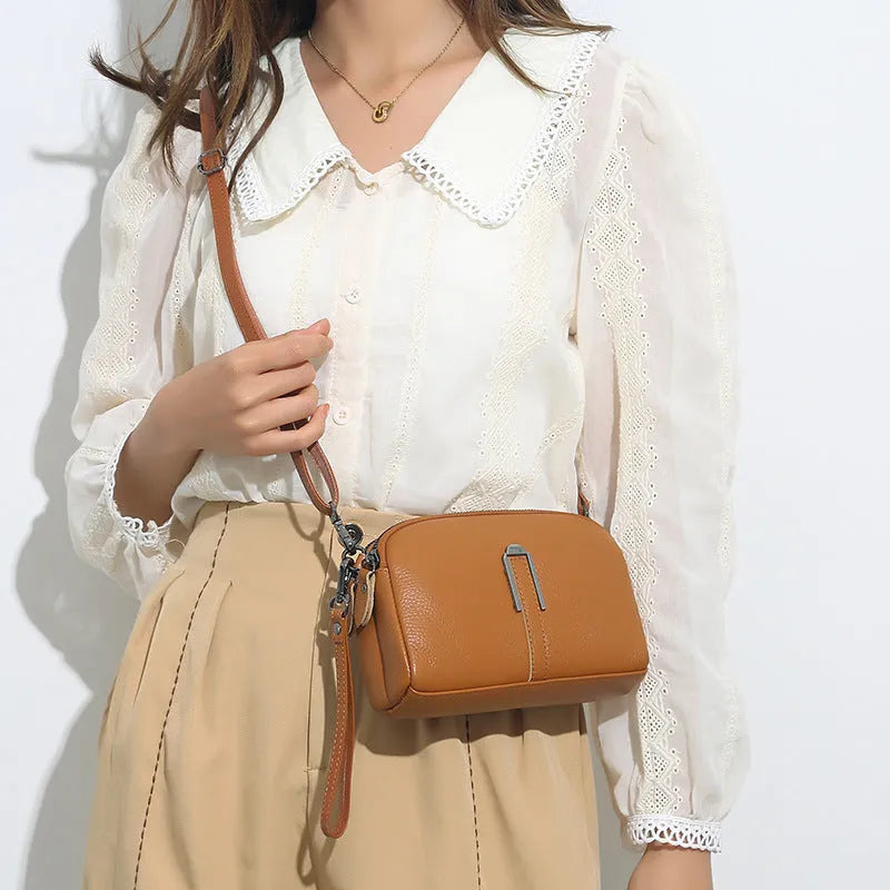 Square genuine leather ladies shoulder bag in dark khaki colour showing structured silhouette.