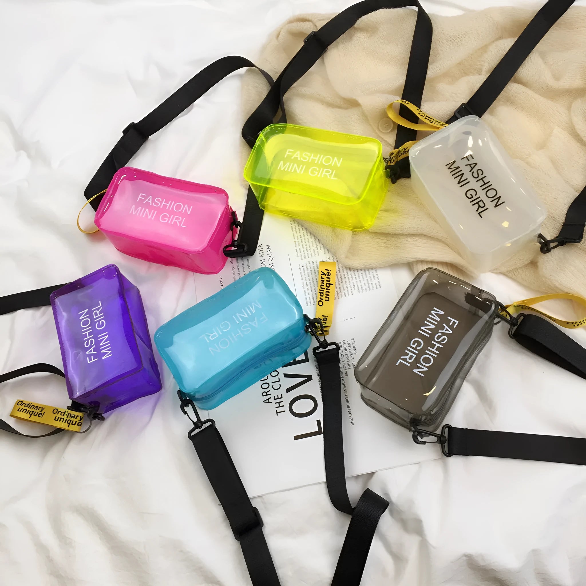 Transparent square jelly shoulder bag with adjustable strap in various colours on a white background.