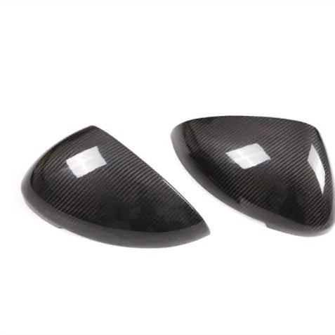 Genuine carbon fibre rearview mirror covers for a Porsche Macan, showing glossy black weave texture.