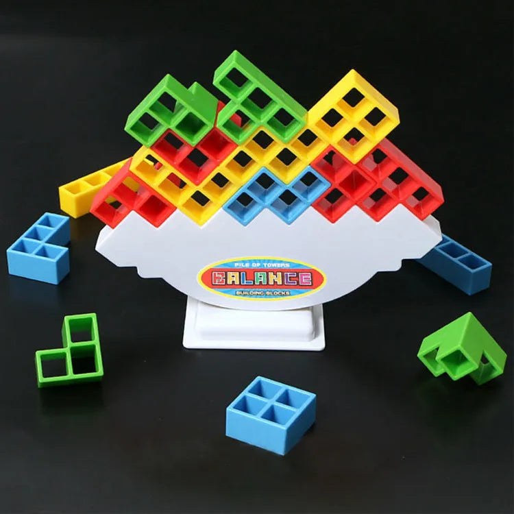 Plastic balance stacking game with 16 colourful building blocks, chassis, and base on a table.
