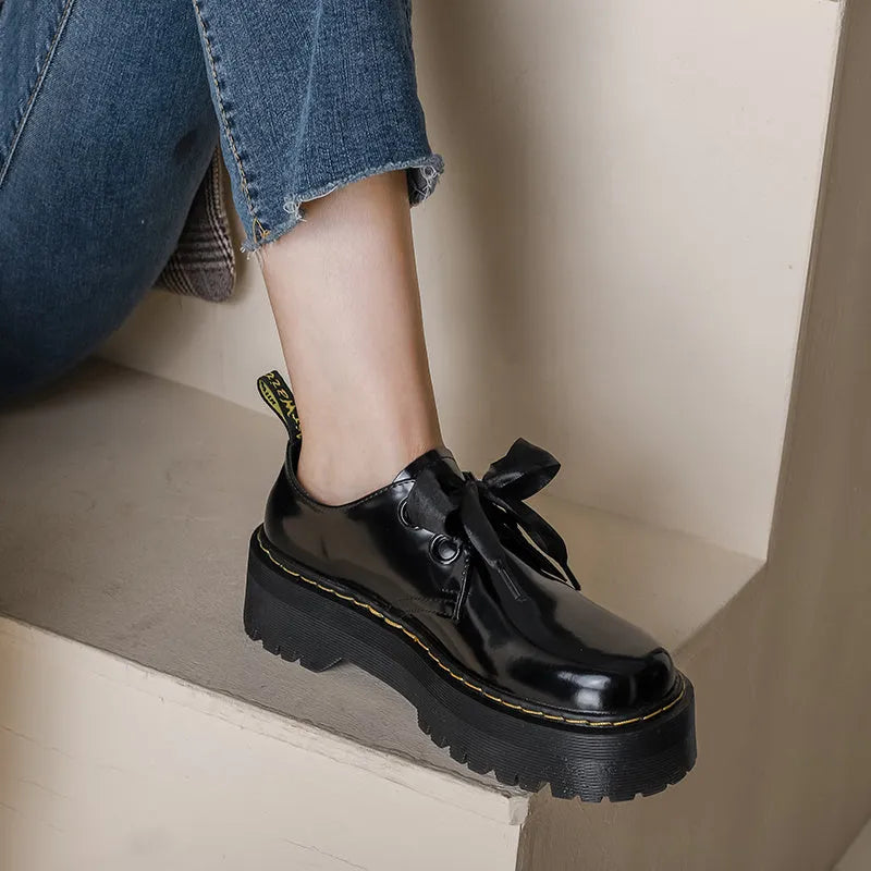 Women's thick soled leather shoes with ribbon details in black and white colour options