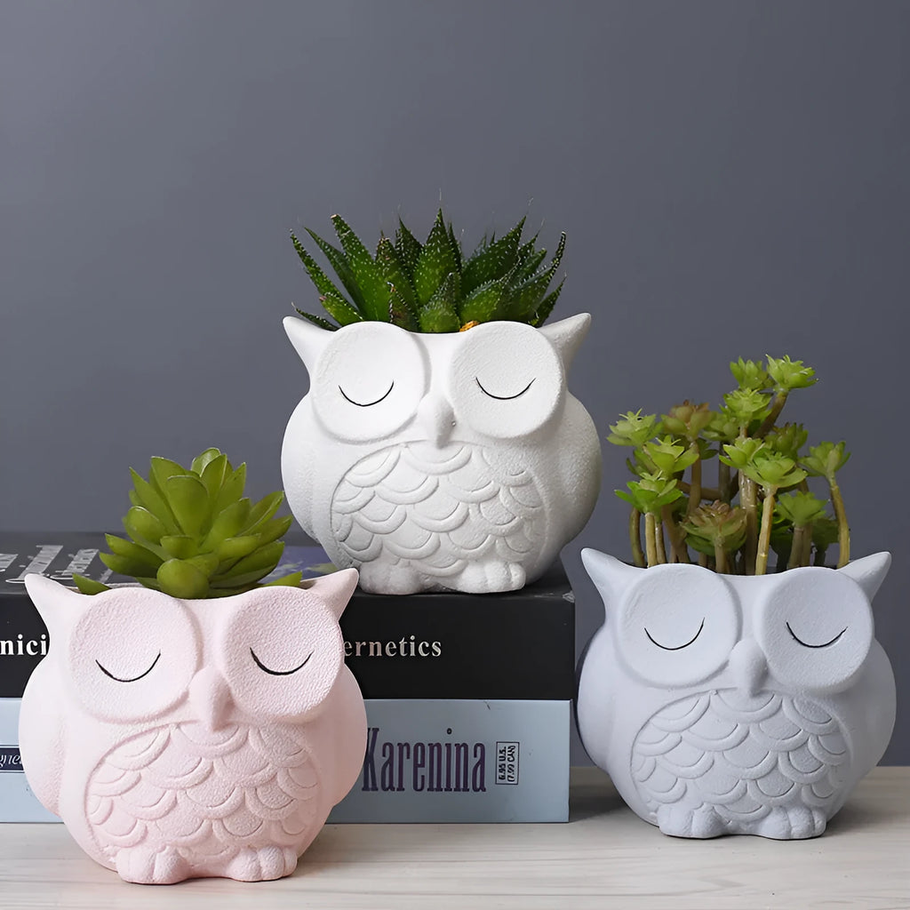 Handmade frosted ceramic owl planter for small succulents, shown in light pink.