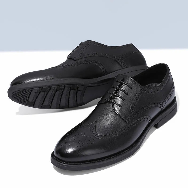 Men's black brogue leather shoes with decorative perforations and lace-up front.