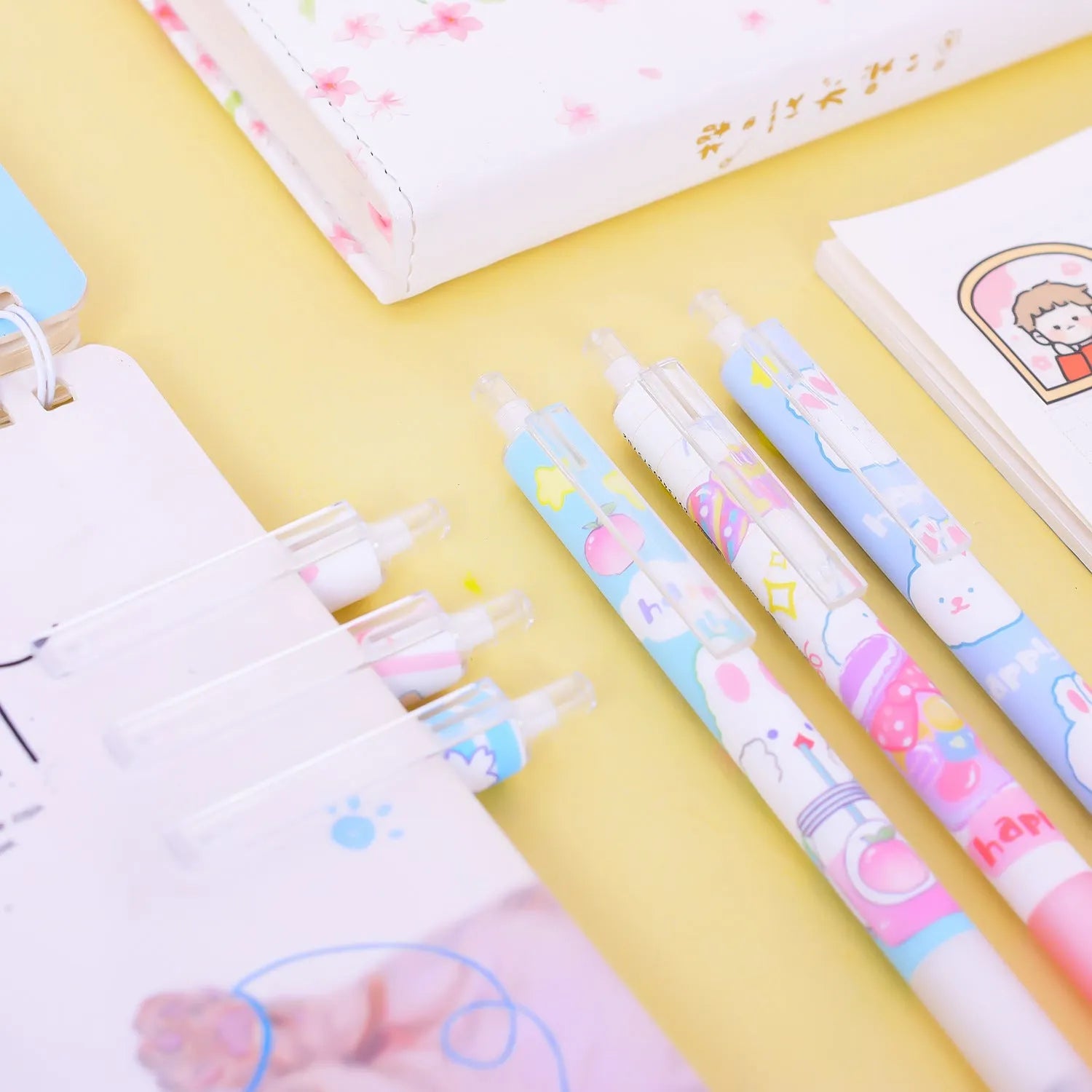 Six Cartoon Bunny brand black plastic pens with 0.5mm tips laid out from their box.