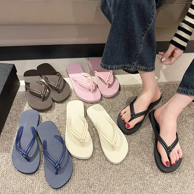 Women's pink PVC closed-toe flip flops with a non-slip sole on a plain background.
