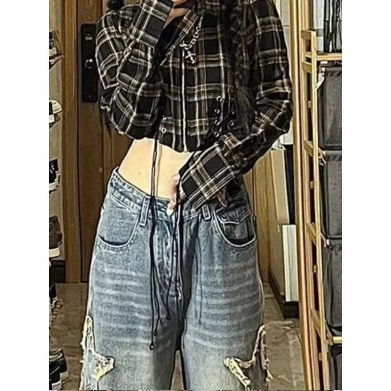 Blue high-waisted wide-leg denim jeans on a neutral background, showing the straight-leg silhouette.
