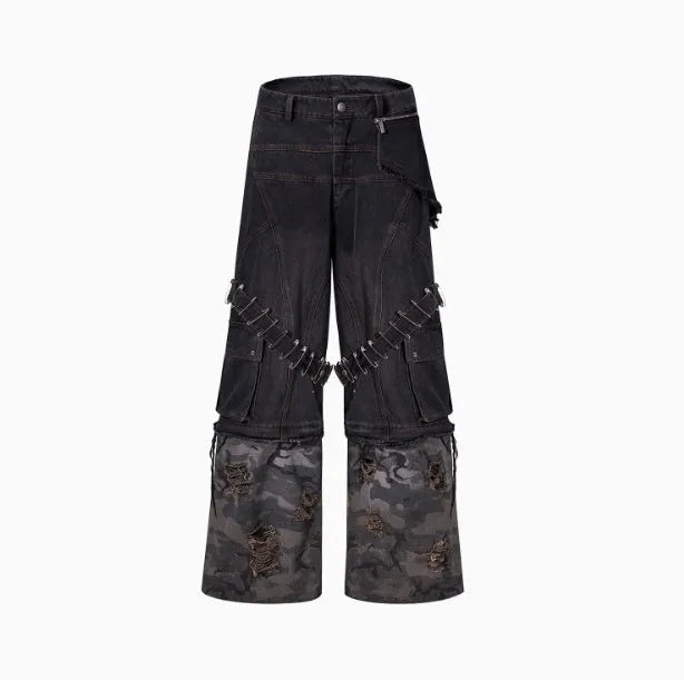 Men's grey camouflage pattern jeans with spliced panels and decorative pin details.