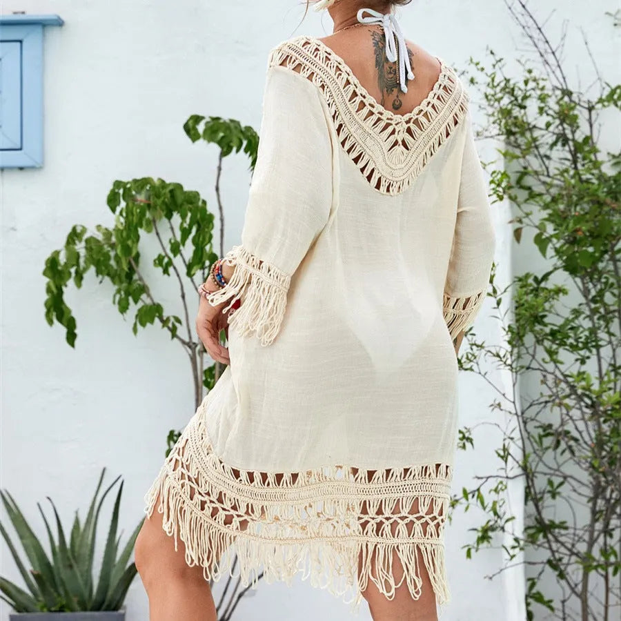 Apricot crocheted patchwork dress with mid-length skirt and half sleeves on hanger