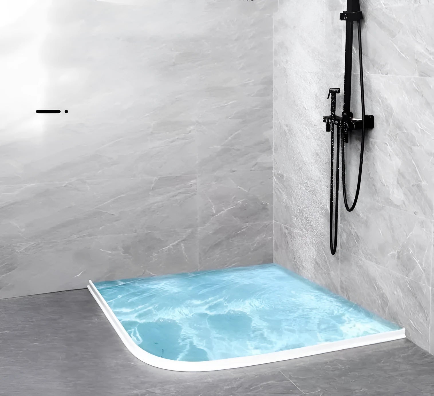 Flexible TPE bathroom water blocking strip in black on white tile floor