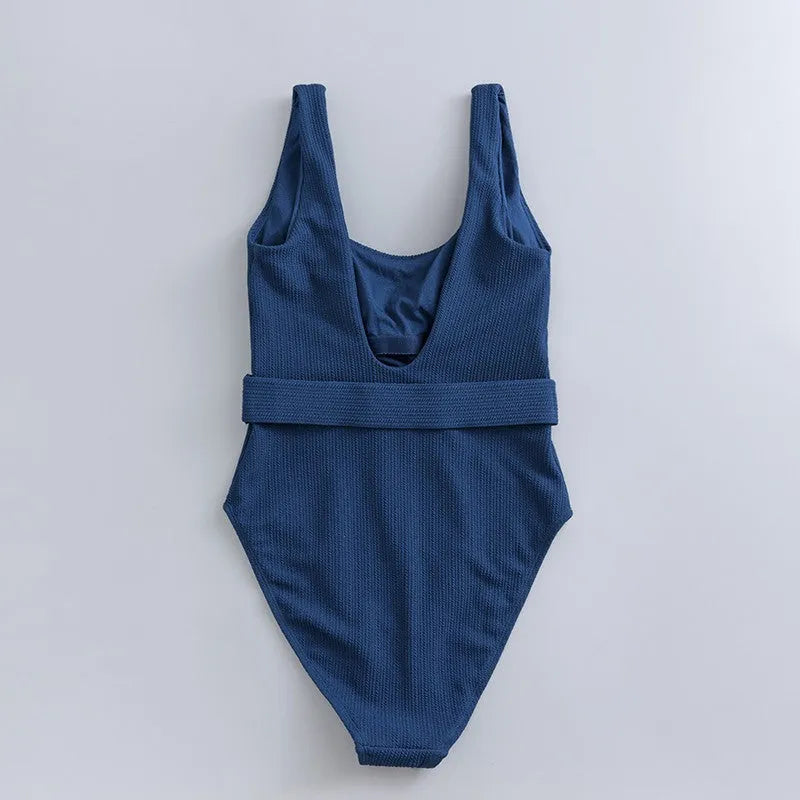 Navy blue women's one-piece swimsuit with slimming triangle design and chest pads
