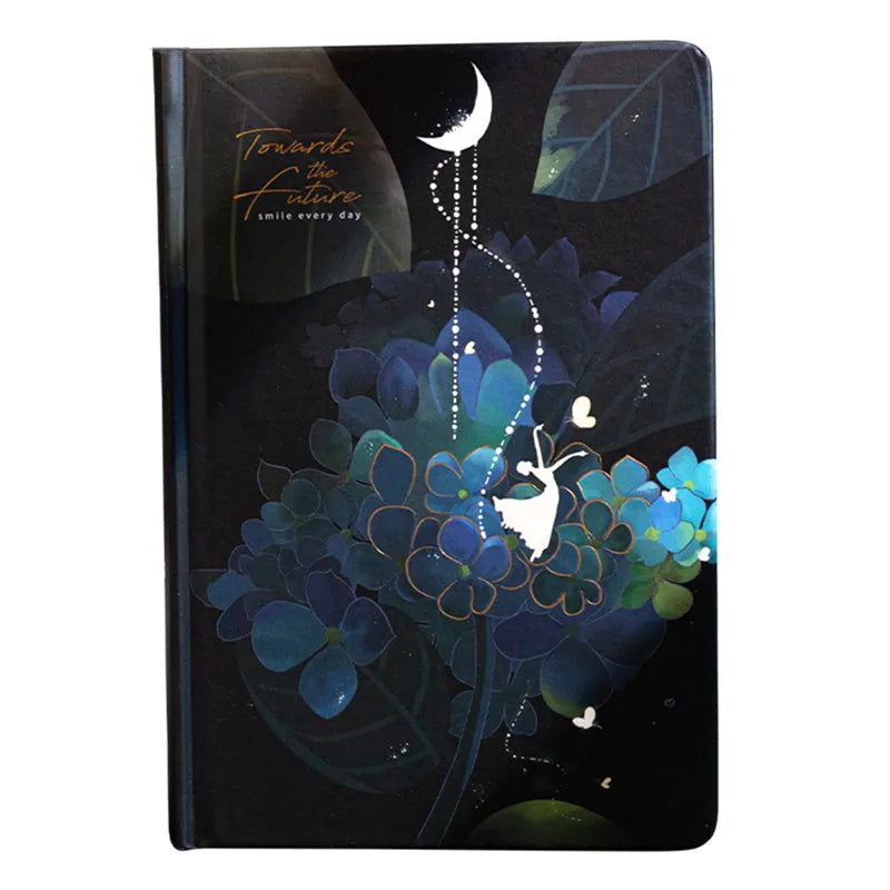 A5 notebook with luminous cover in blue, gold, light blue, or purple, open to show pages for colour illustration.