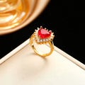 Gold and red titanium steel heart necklace set with mixed gem pendant, stud earrings and ring on white background