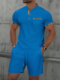 Men's grey waffle zipper polo collar short sleeve top with matching shorts laid flat