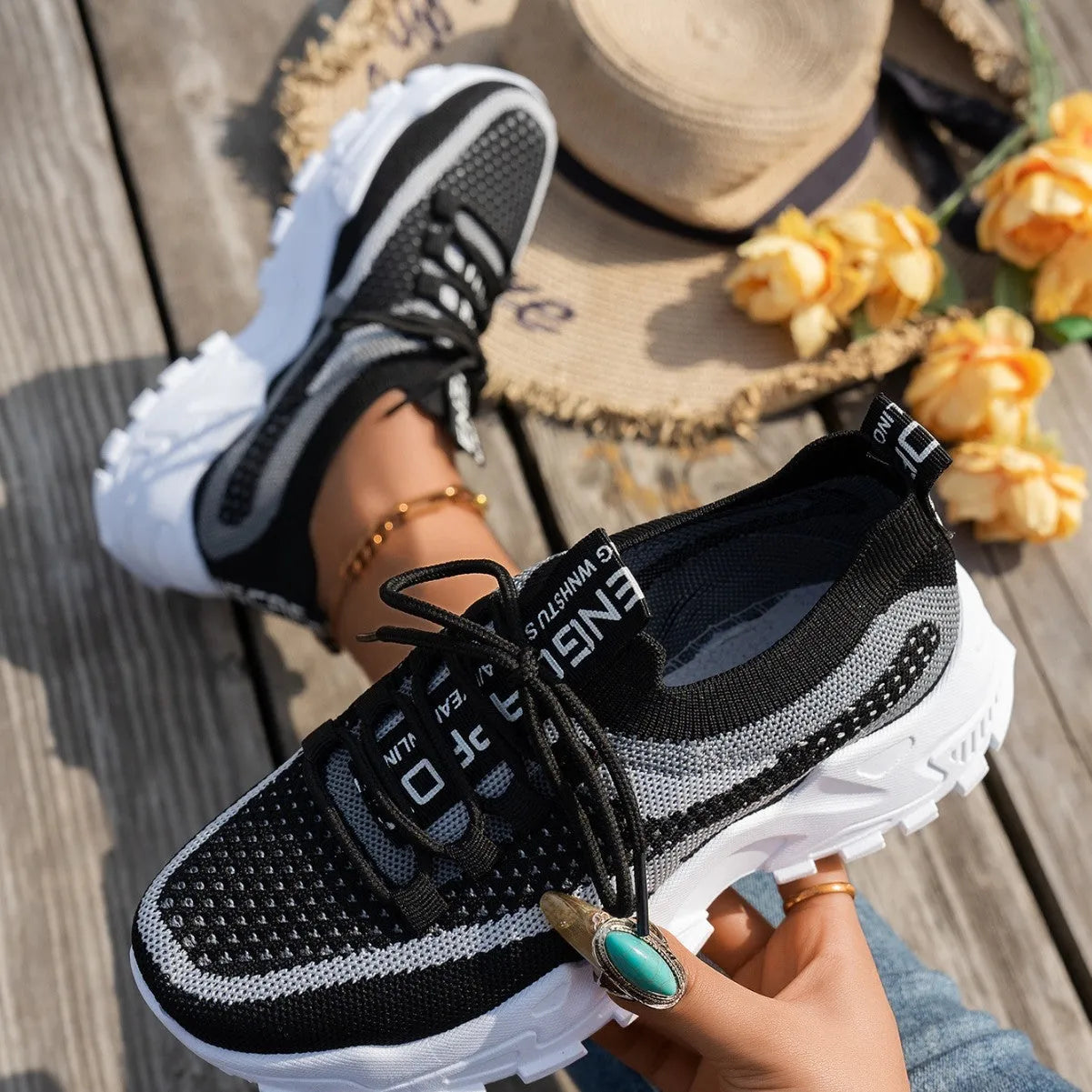 Women's Flyknit mesh lace-up sneakers in a multi-tonal colour with a flat rubber sole.