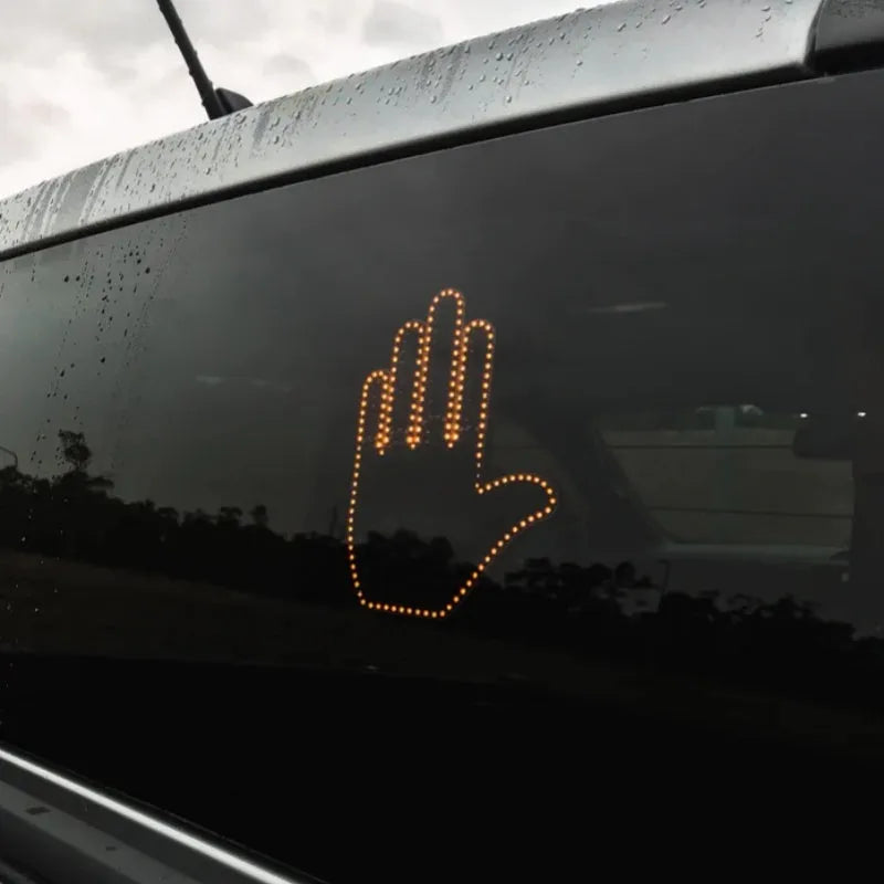 Black plastic LED gesture light for cars showing middle finger symbol with remote control