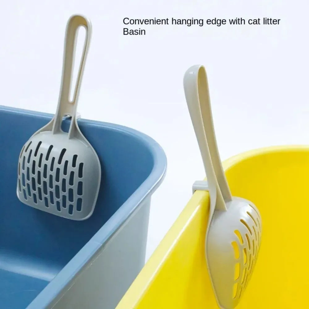 Grey plastic cat litter scoop with anti-slip handle sitting on its matching plastic base tray.