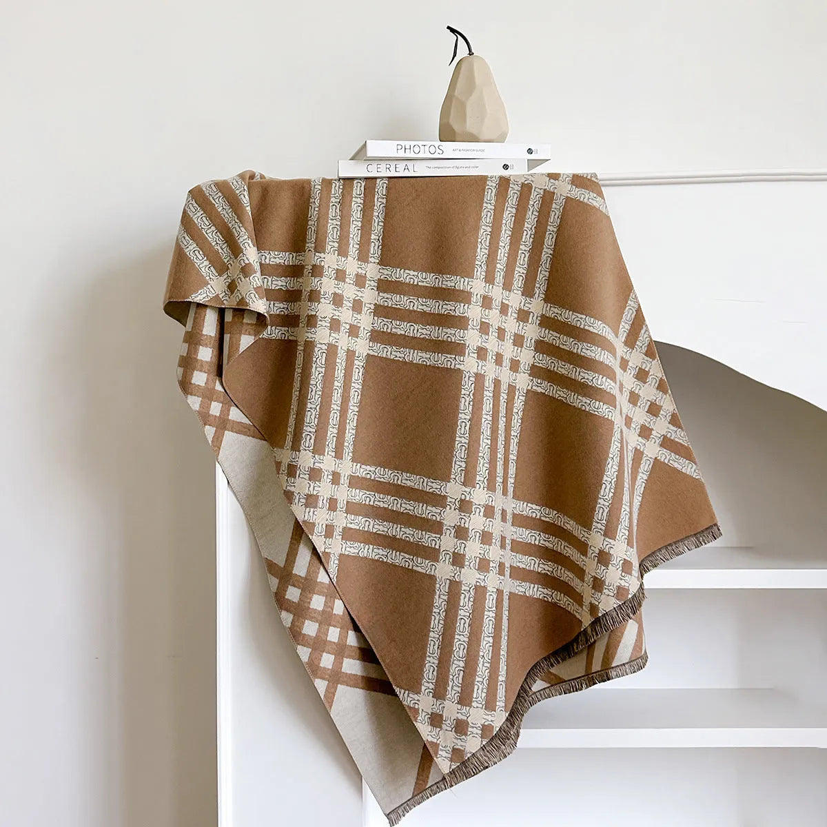 Mid-length brown cashmere-like scarf with tassel ends laid flat.