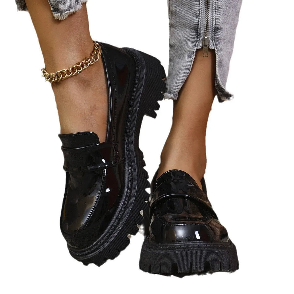 Women's black chunky heel slip-on loafers with a platform rubber sole.