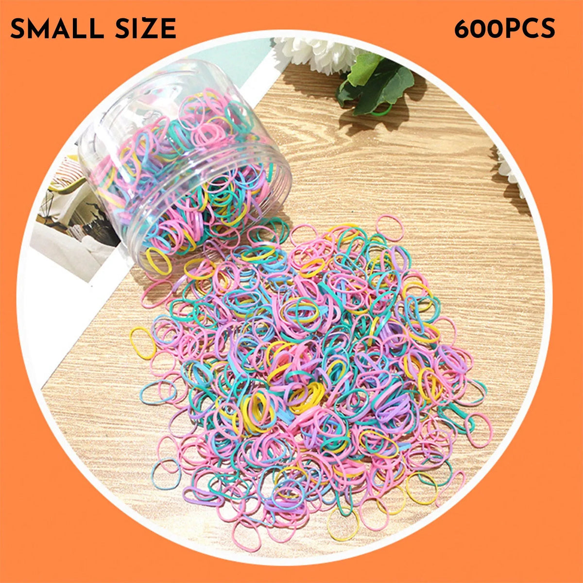 Assortment of colourful small TPU baby hair ties in a reusable plastic container.