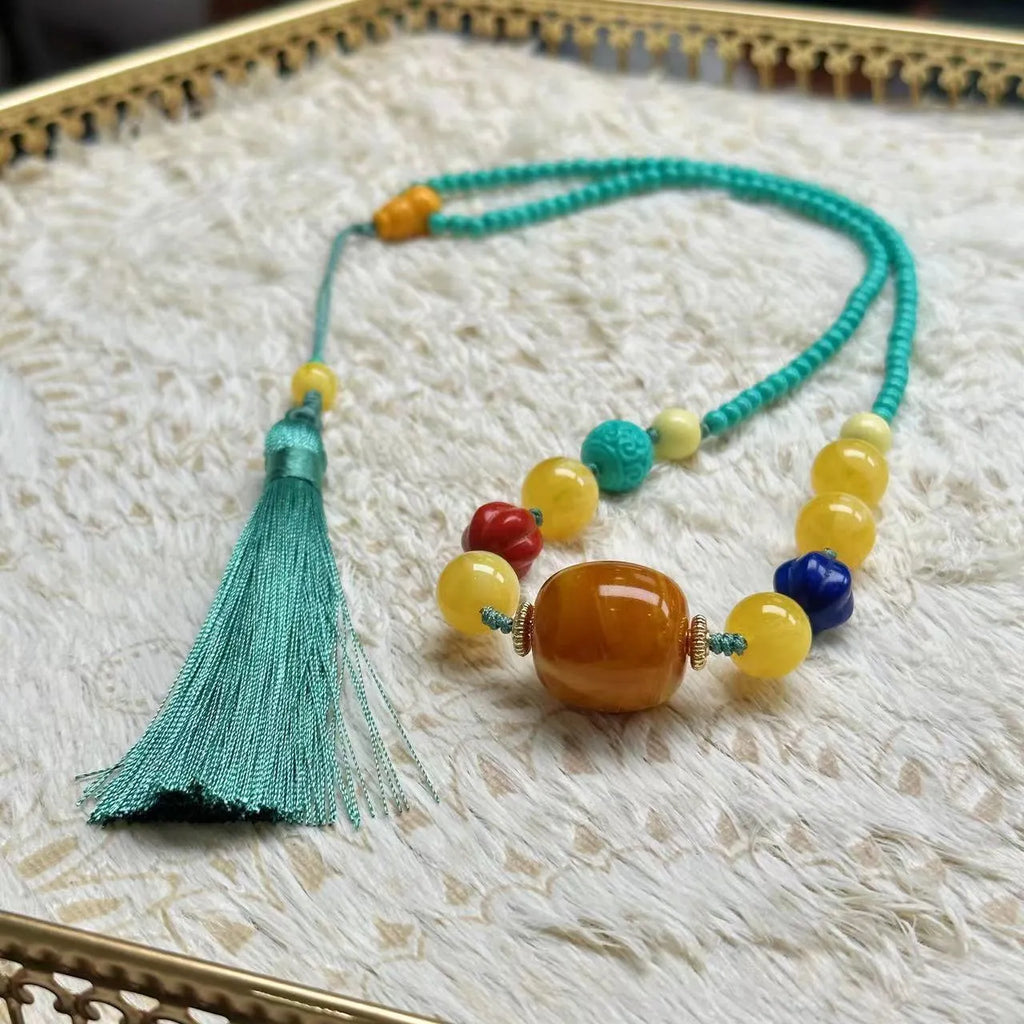 Turquoise necklace with stone pendant on ball bead chain, showing mesh flower design