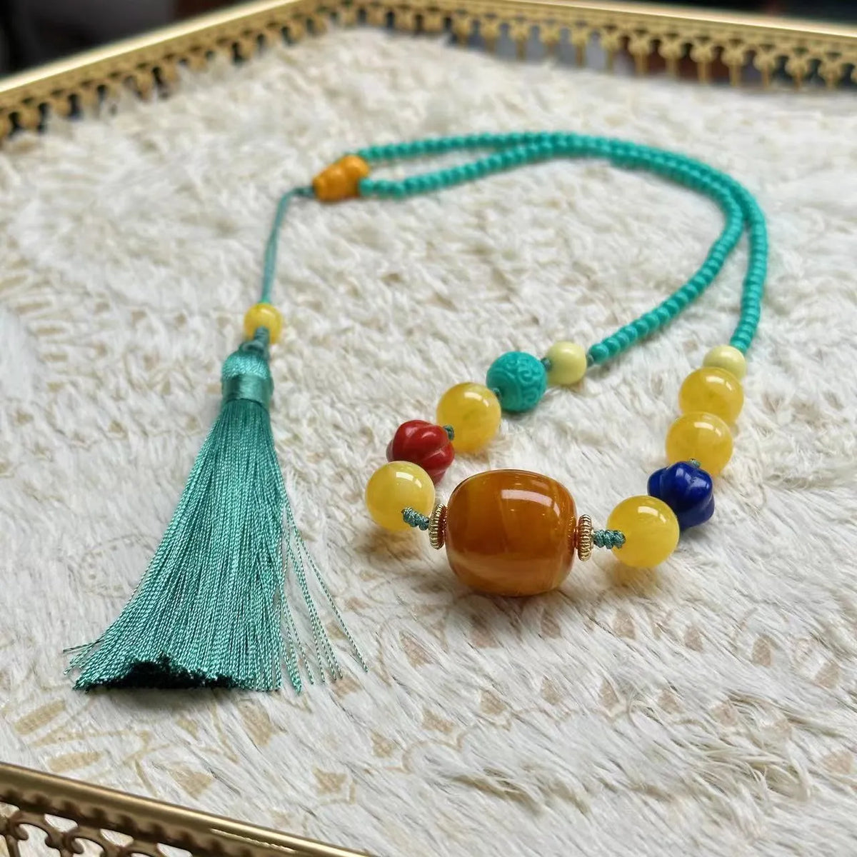 Turquoise necklace with stone pendant on ball bead chain, showing mesh flower design