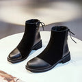 Women's black knee-high Martin boots with side zip and decorative bow detail
