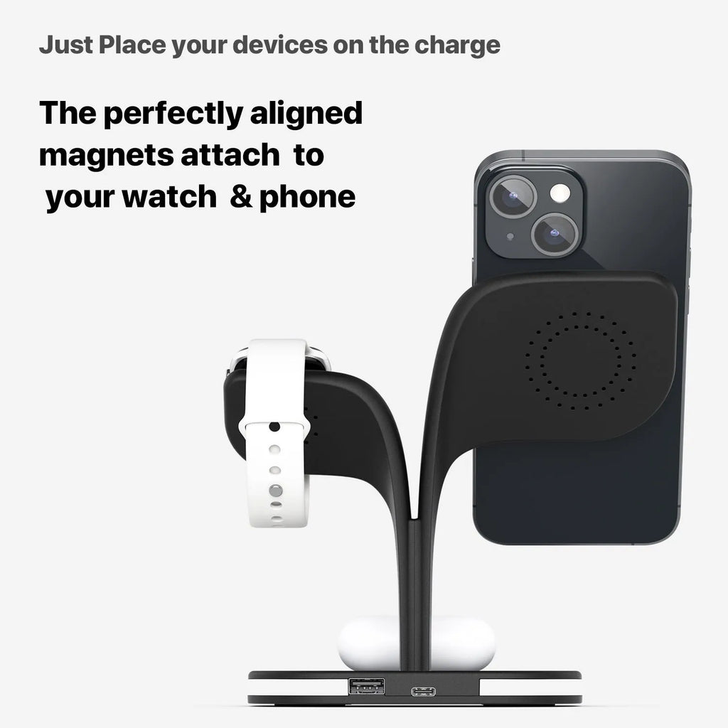 Black and white wireless charging stand for phone, watch, and headphones on a desk.