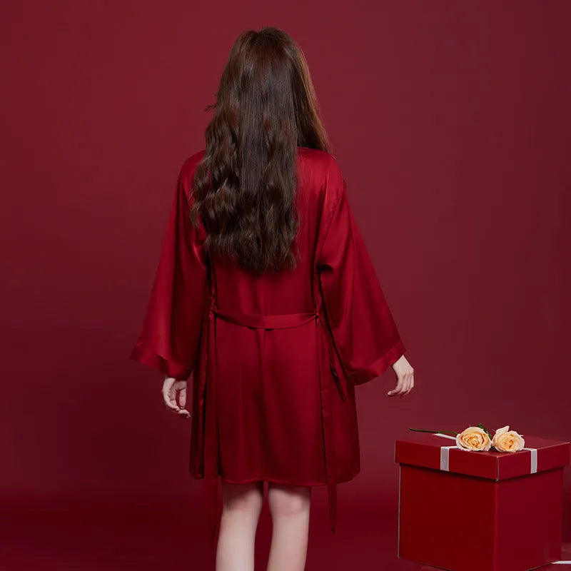 Red polyester wedding dowry suit set for a man and woman, featuring long sleeves and trousers.