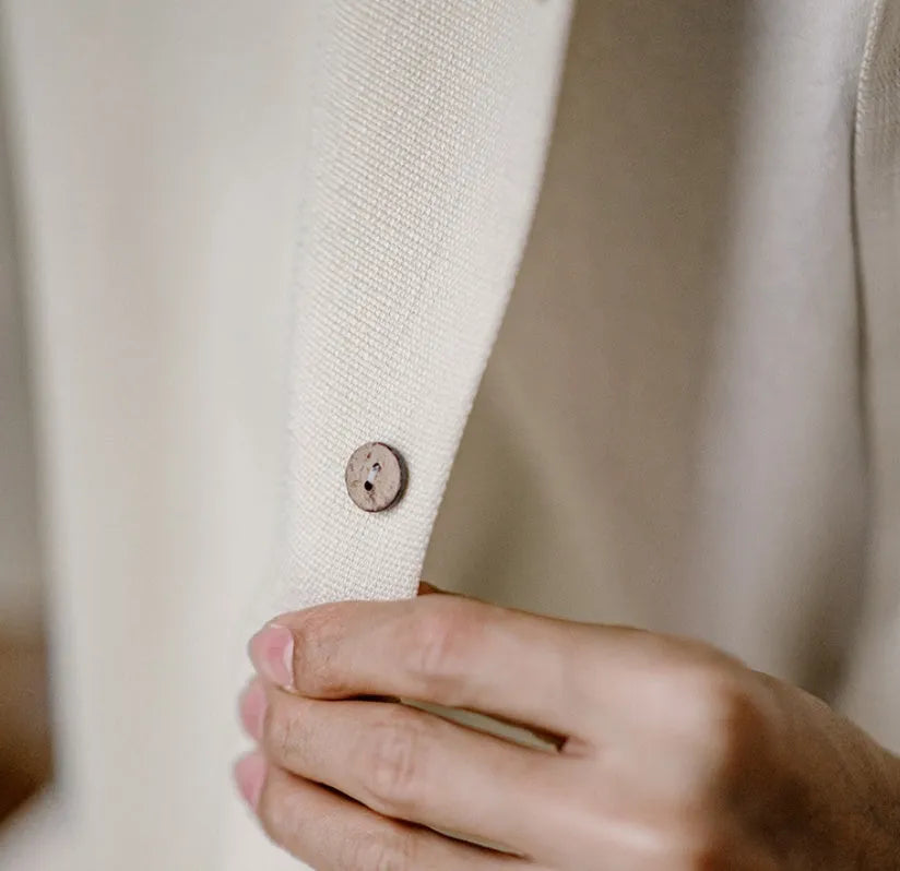 Light apricot men's shirt with bamboo pattern and Cuban collar laid flat.