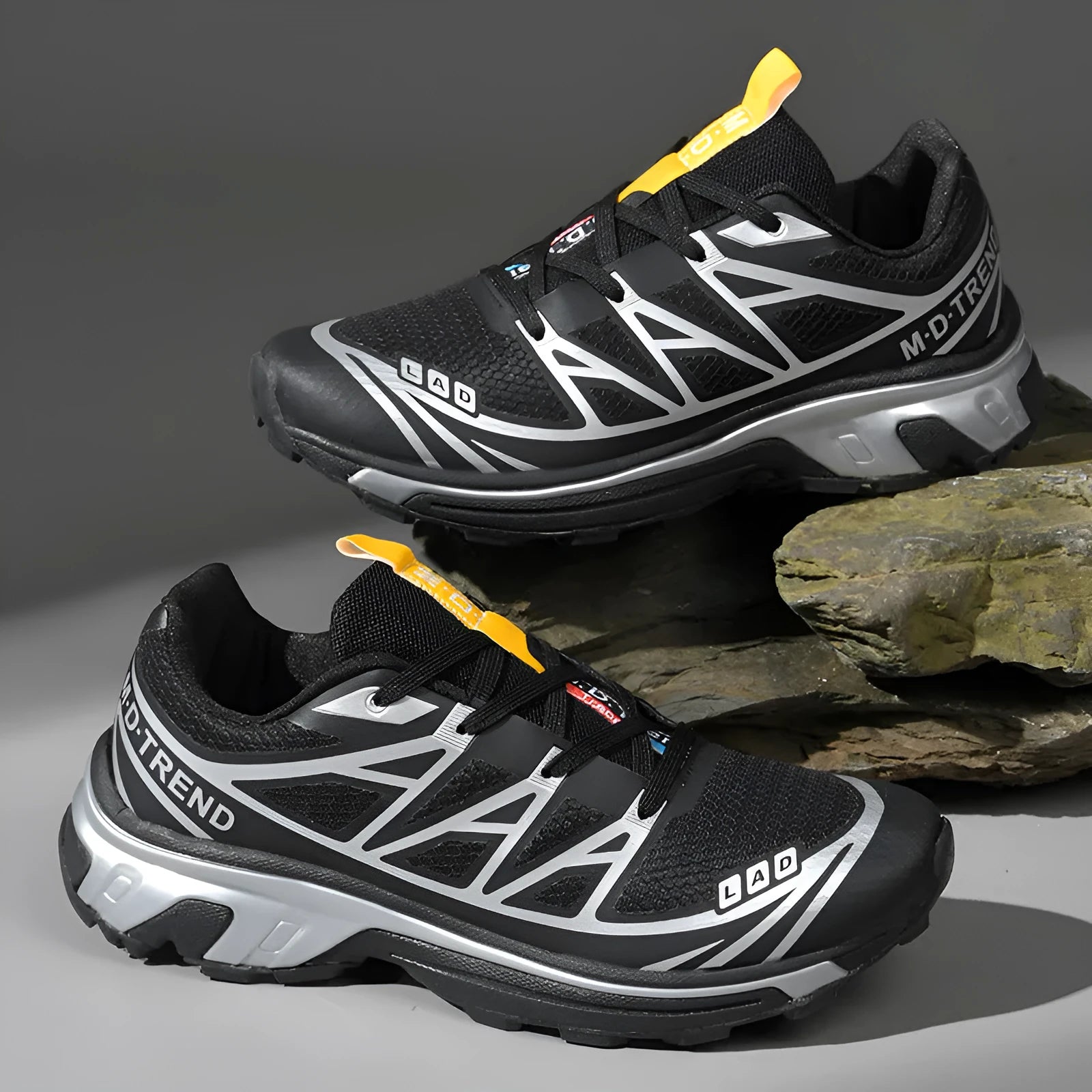 Men's and women's low-top black and grey hiking shoes with rubber sole and lace-up front.