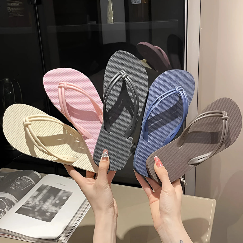 Women's pink PVC closed-toe flip flops with a non-slip sole on a plain background.