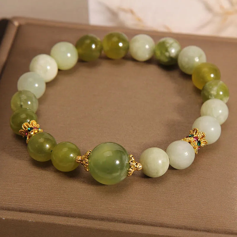 Xiuyan jade green women's bracelet with original design on a wrist.