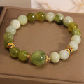 Xiuyan jade green women's bracelet with original design on a wrist.