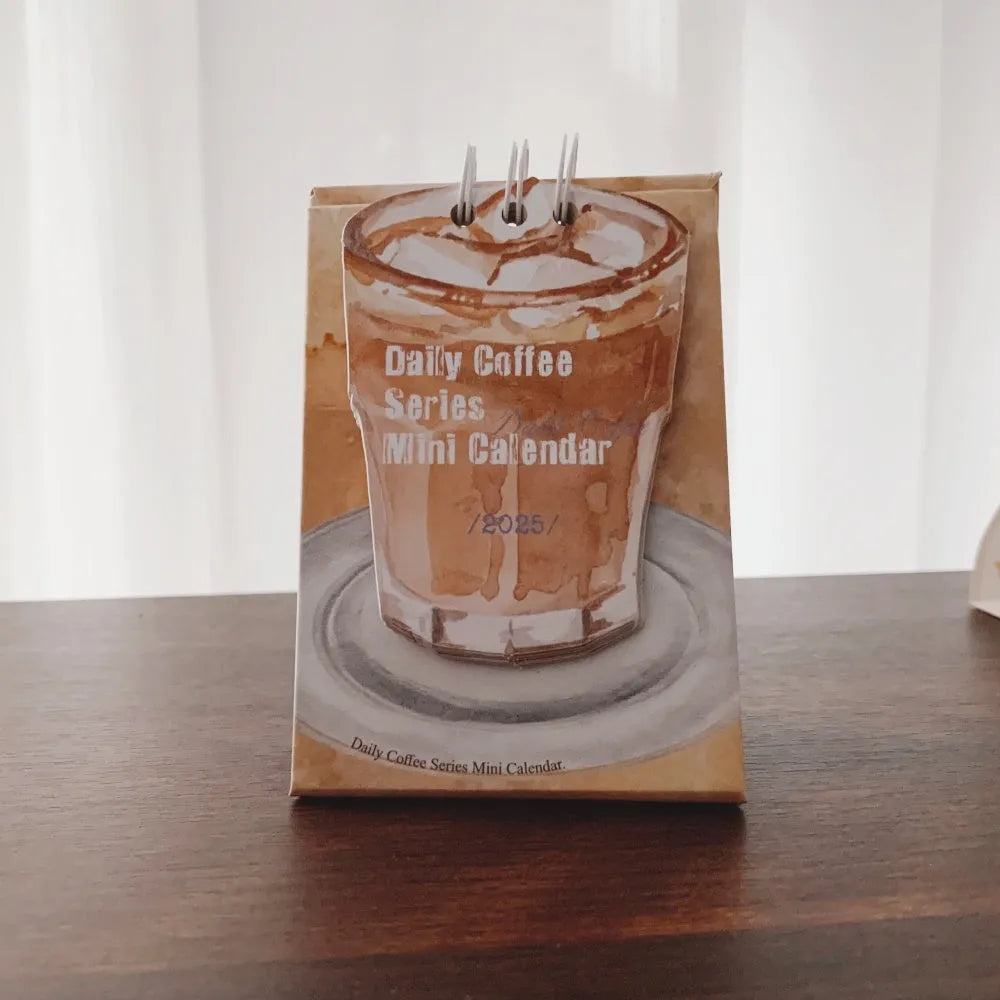Coffee themed mini desk calendar for 2025 showing four different model designs on a desk.
