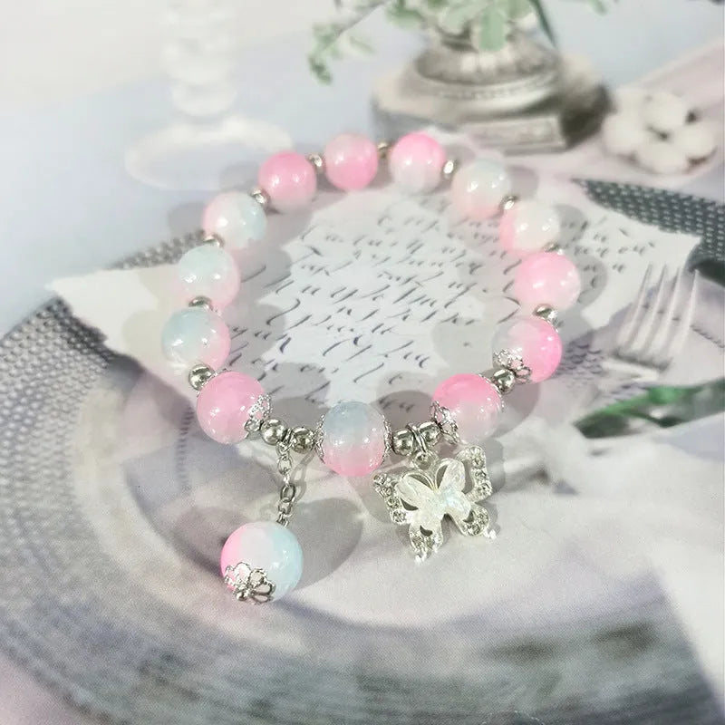 Chinese style handmade glass bead bracelet with bamboo joint elements on a white background.