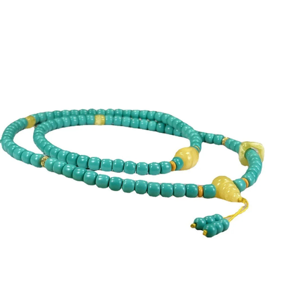 Turquoise necklace with stone pendant on ball bead chain, showing mesh flower design