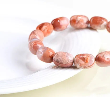 Natural cherry agate bracelet with geometric barrel beads and a Ruyi design detail.