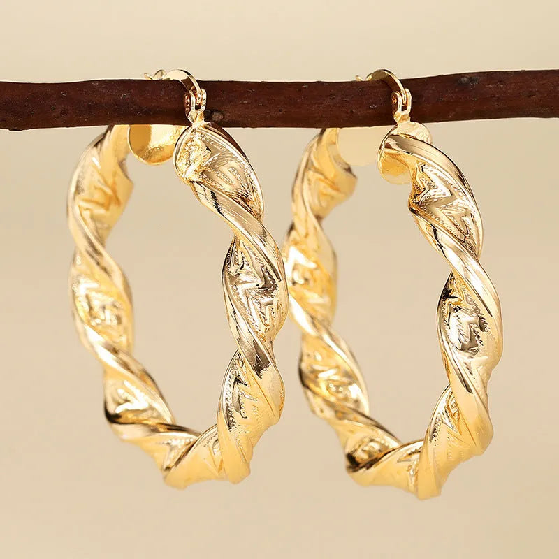 Geometric drop-shaped ear clips with ring and line design in metallic finish