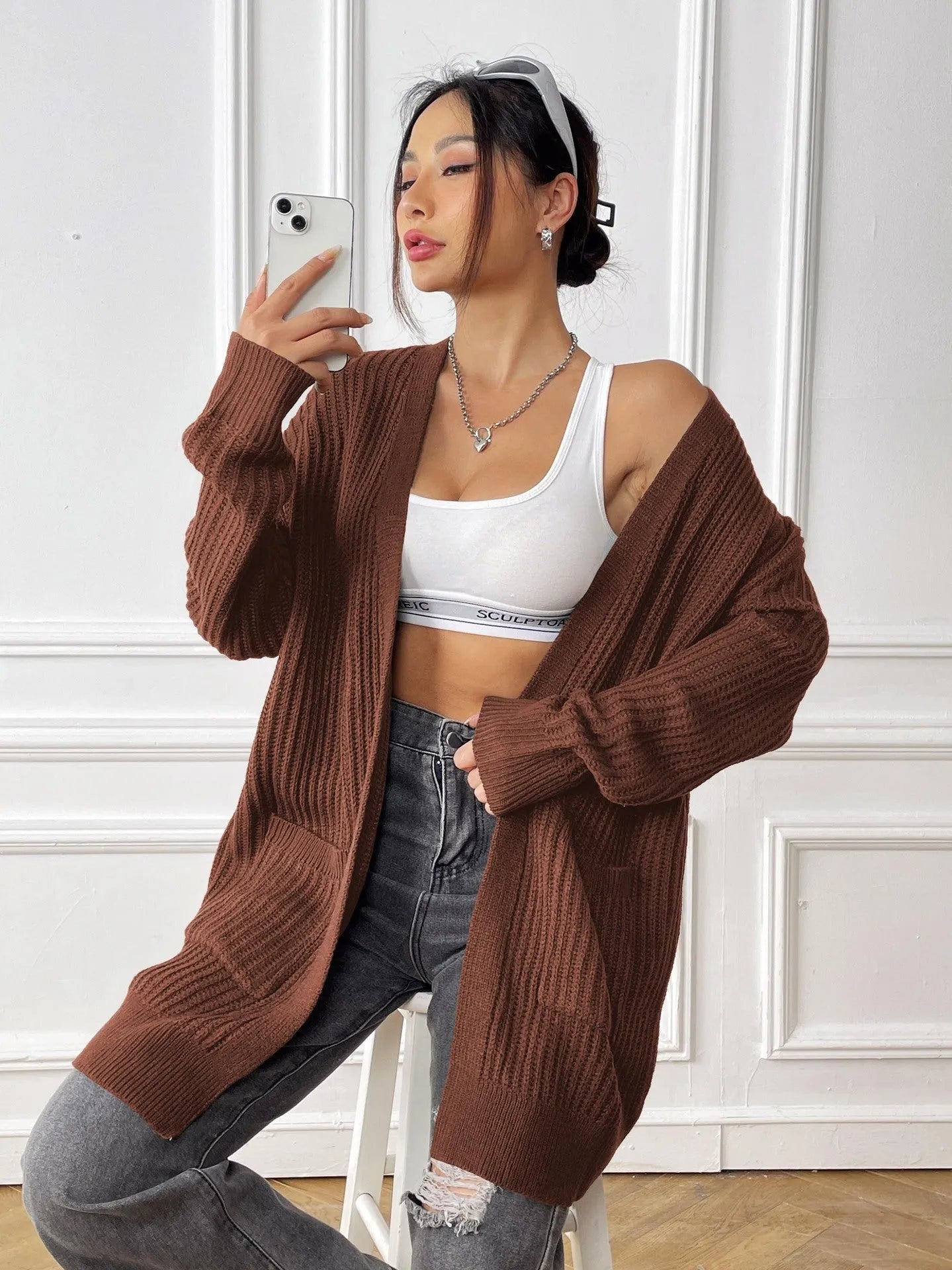 Women's loose fit acrylic cardigan sweater with double pockets in dark green colour