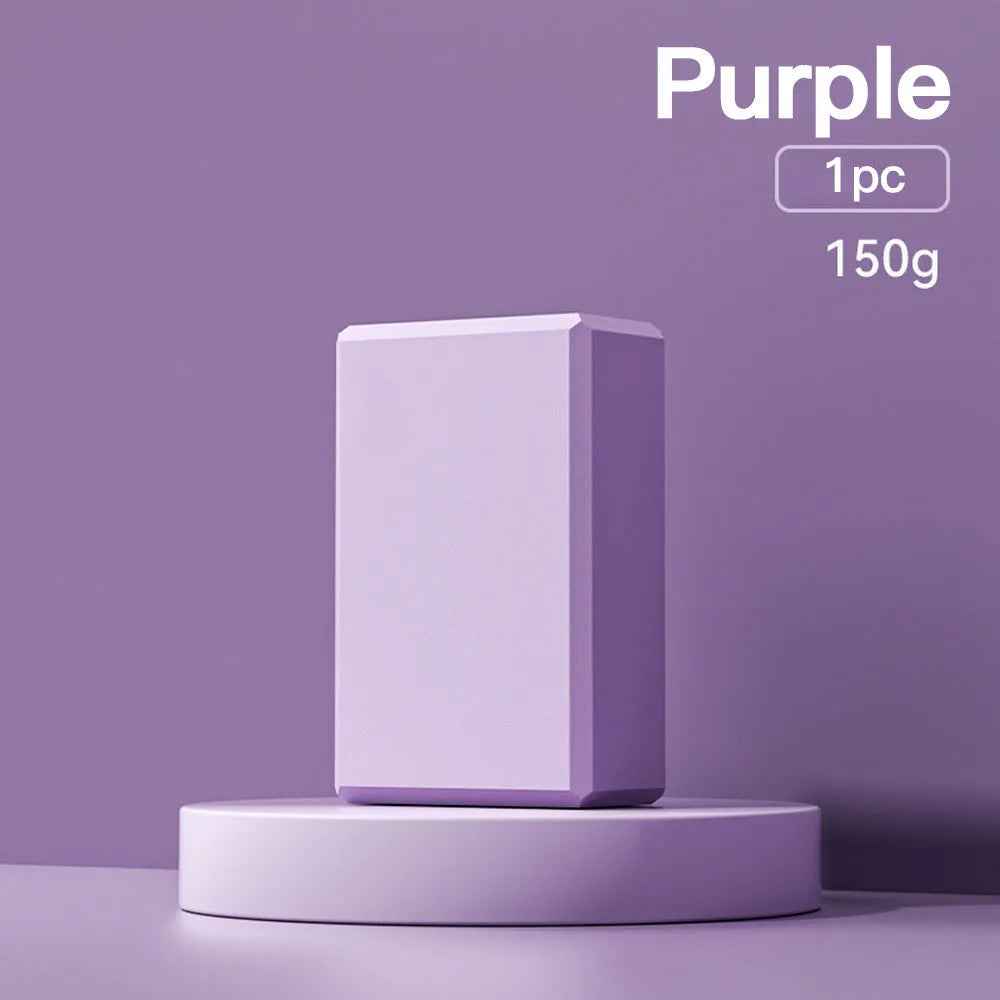 Solid colour EVA foam yoga brick block with hexagonal facets for grip, measuring 23x15x7.6cm.