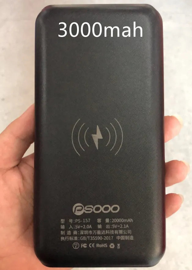 Black portable power bank with Qi wireless charging pad and three USB ports on the side