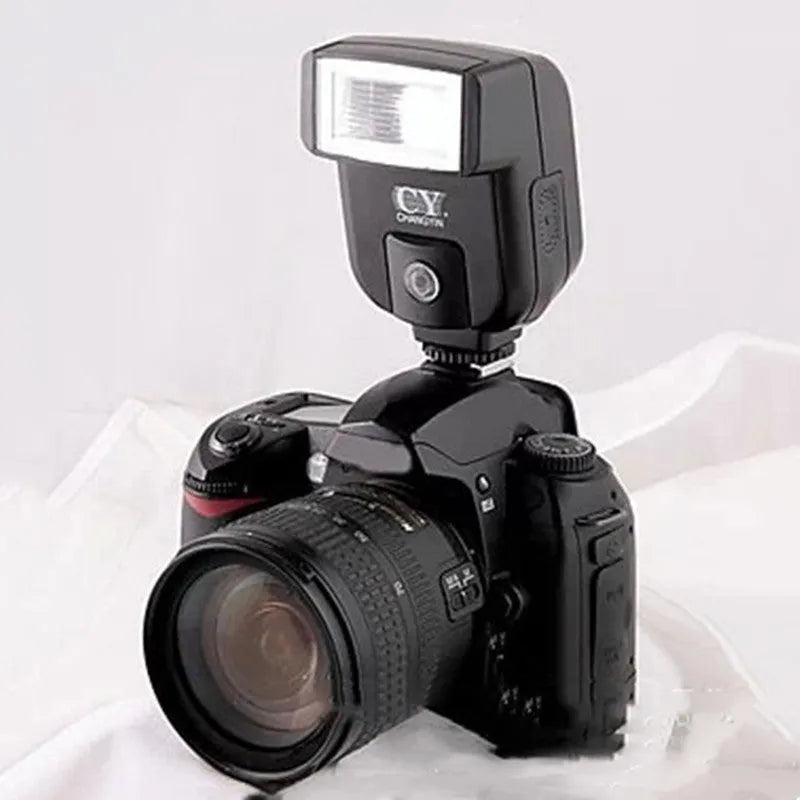 Compact black camera flash unit with tilt head showing GN20 specification and 5600K colour temperature label
