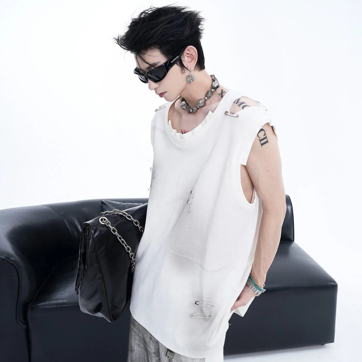 Men's black sleeveless vest waistcoat with ripped irregular cutting design on mannequin