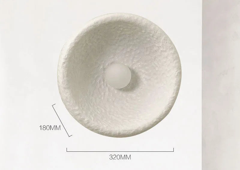 Japanese-style modern simple wall lamp with a round resin shade in warm white light.