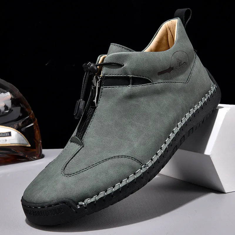 Men's black casual leather sneakers with a mid heel and round toe on a rubber sole.