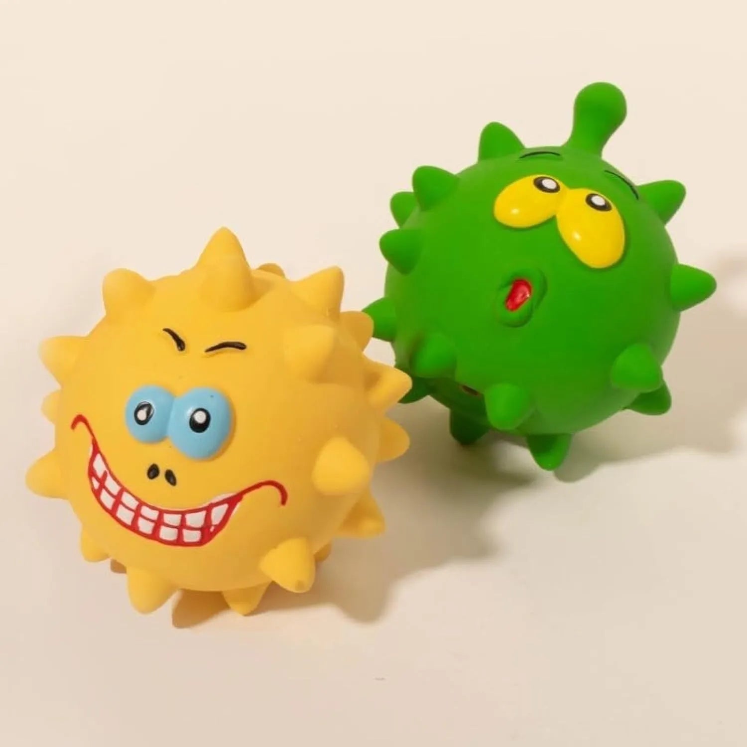 Set of colourful natural latex dog squeaky balls with bumpy surfaces and cute faces for teeth cleaning play