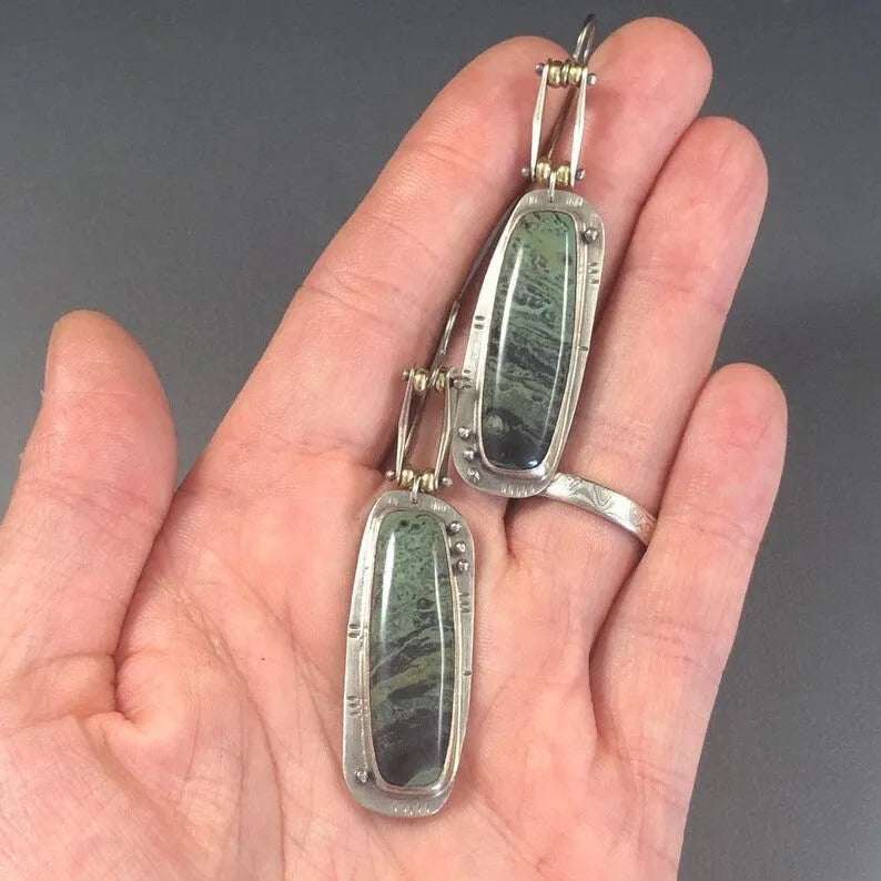 Two-colour marble pattern geometric alloy drop earrings on a white background.